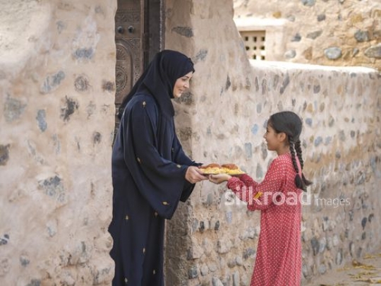 Giving plate to woman|-
