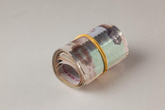 an uae dirhams rolled up