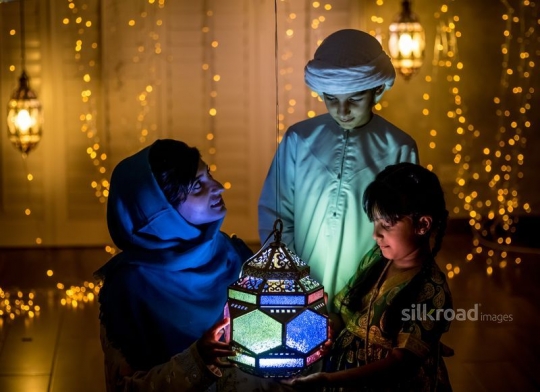 Mother with kids enjoying ramadan lanterns|-