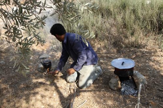 Preparing food on campfire