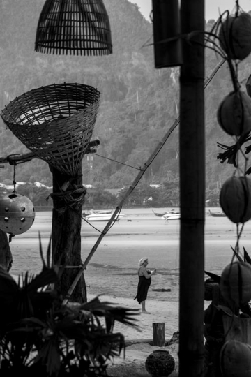 distant woman standing by the shore 