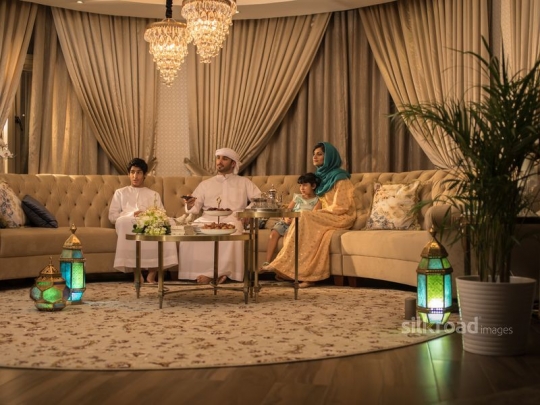 Family around TV in Ramadan|-