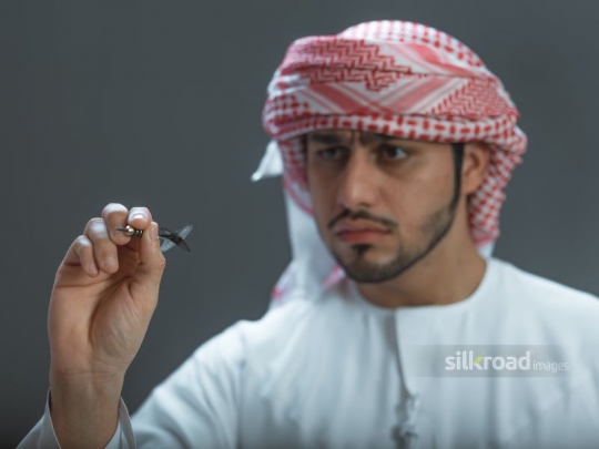 Middle Eastern man playing darts