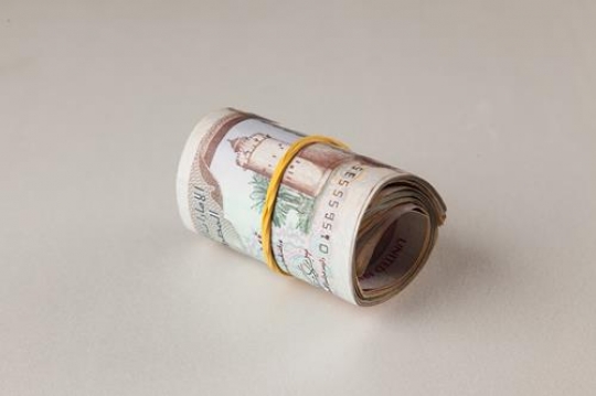 an uae dirhams rolled up