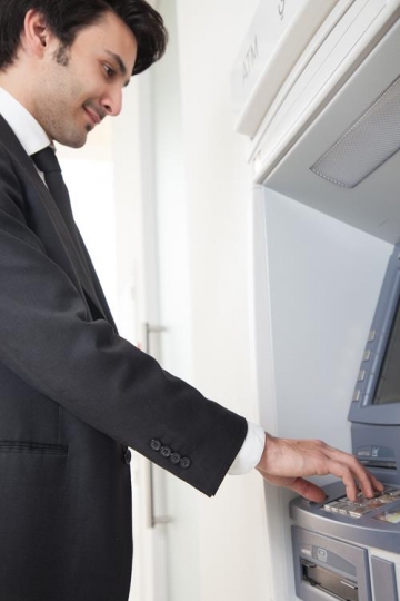 man at automatic teller machine