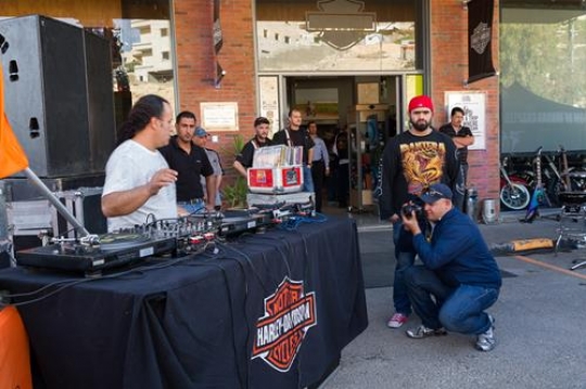 photo of adult dj working with his equipment