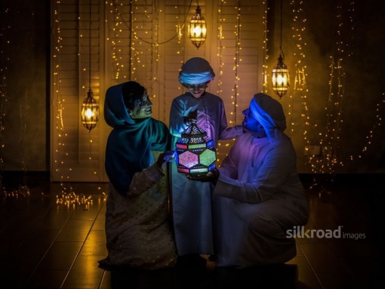 Parents with son holding lantern|-