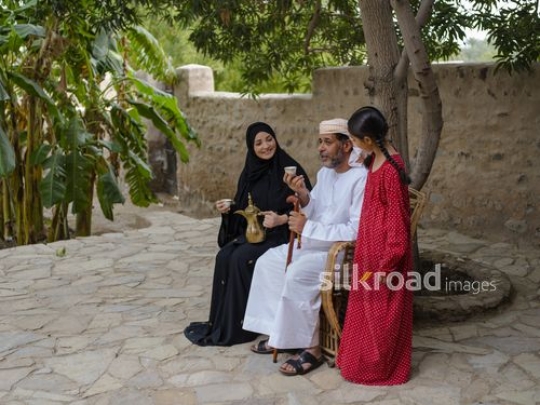 Family enjoying coffee on the bench|-