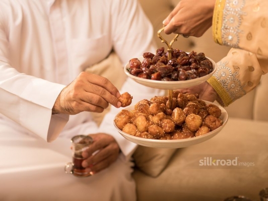 Serving Arabic sweets|-