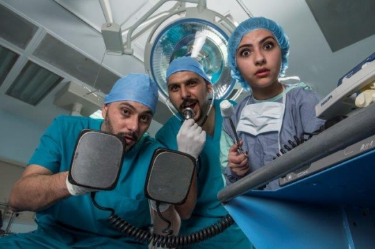 Surgeons Holding Electric Cardioversion and Surgical Tools