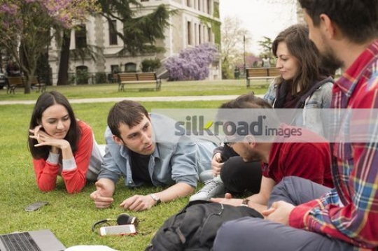 Group of boys and girls sitting together|