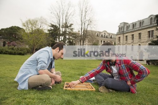 Two friends playing a game on campus 