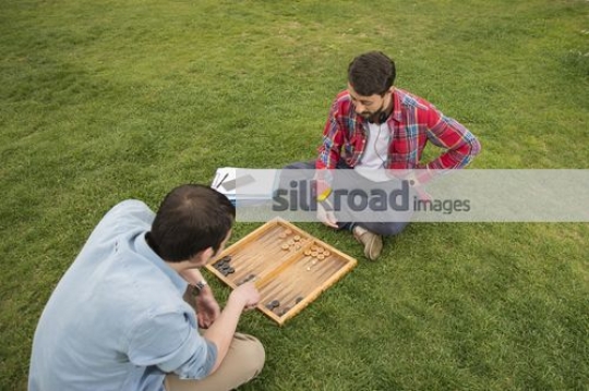 University students sitting together playing a game|