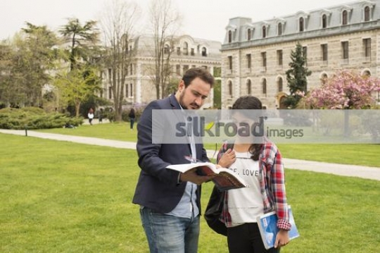 University Student talking to the professor|