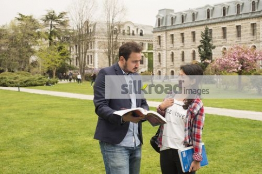 Student talking to the professor|
