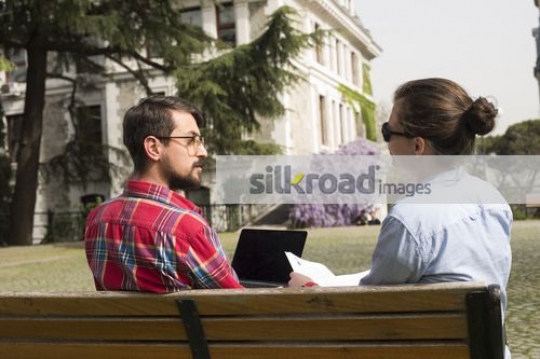 European Students sitting on the bench together|