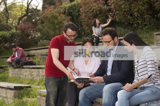 Students sitting together talking to the professor|
