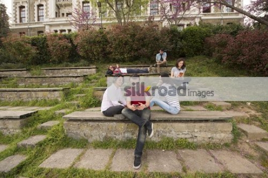 University Students sitting together talking|