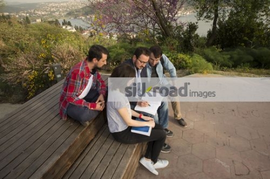 University students sitting talking to the professor|