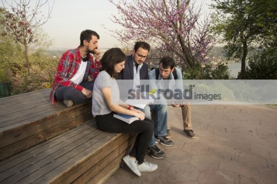 Friends talking to the professor|