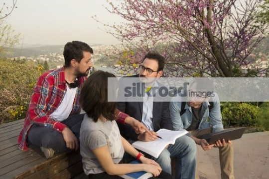 Students sitting talking to the professor|