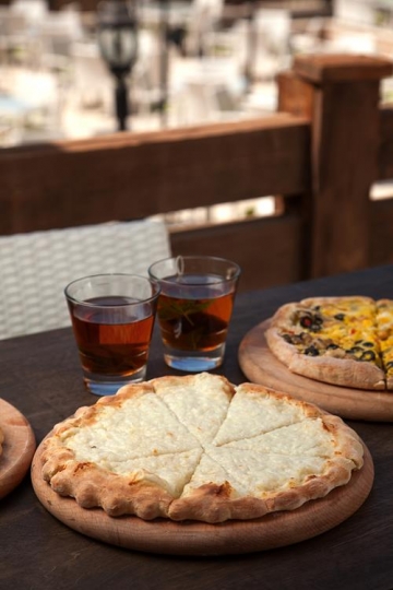 two cups of tea with a pizza a