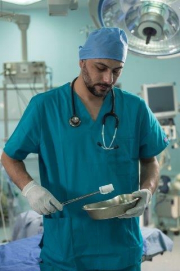 Surgeon Preparing Surgical Tools for Surgery
