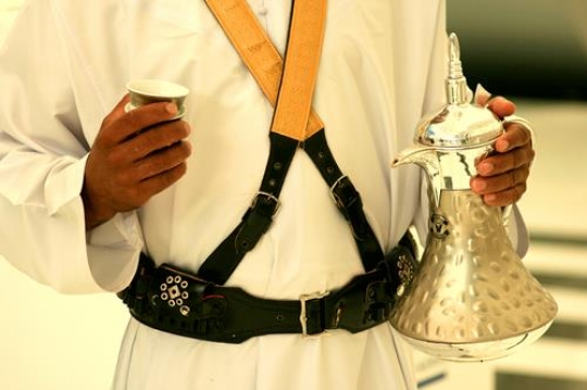 man holding arabic dallah