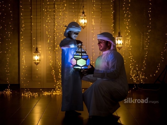 father with his son holding lantern|-