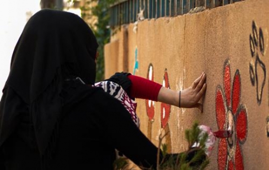 two girls drawing on the wall 