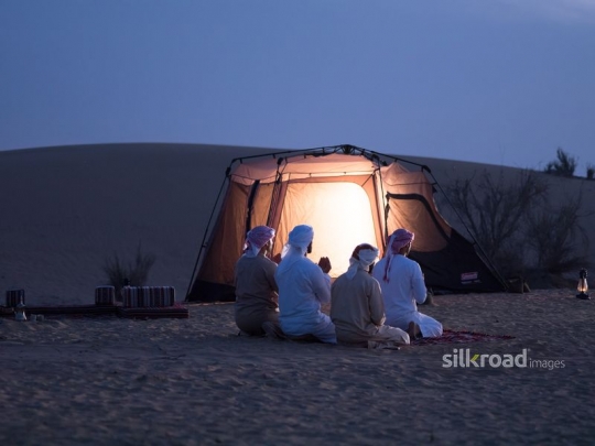 Friends raising hands in prayer