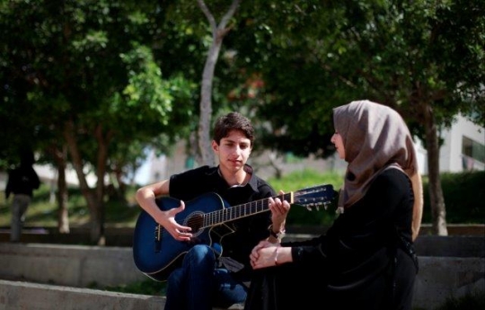 Palestinian Youth Playing Guitar