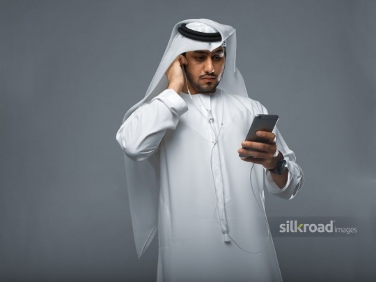 Young Emirati communicating