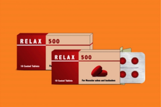 pills in plaster pack in package on orange background