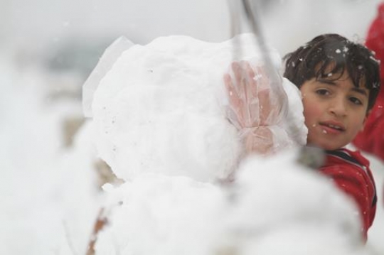 Fresh snow cover, at winter in Palestine, everbody happy and outside and play in the snow