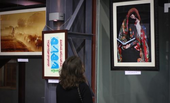 woman looking at a photo on the wall
