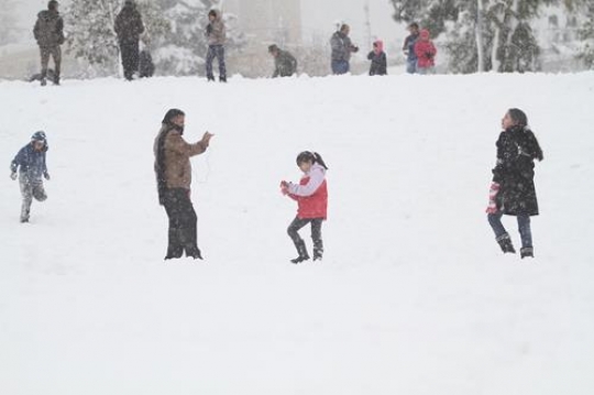 Fresh snow cover, at winter in Palestine, everbody happy and outside and play in the snow