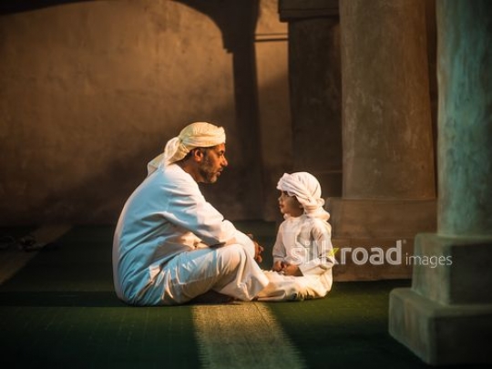 Boy with grandfather at the mosque|-