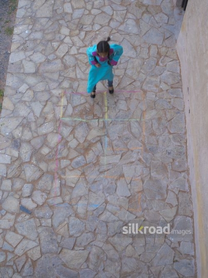 Litte girl jumping outside|-