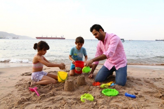 Family Having Fun By The Beach