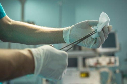 A Surgeon Holding Scissors and