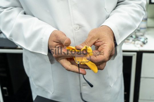 Doctor Carefully Cleaning Eyeglasses