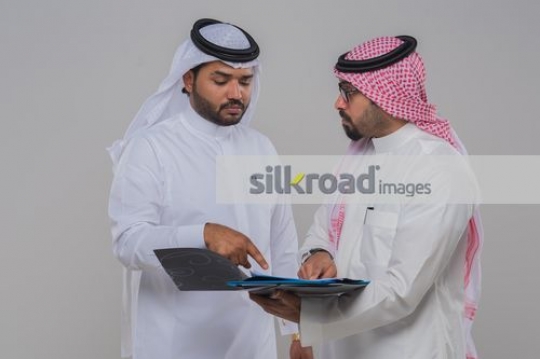 Arab Businessmen talking to each other about work|