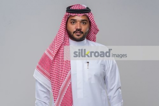 Medium shot of an Arab Businessman dressed in a traditional attire|