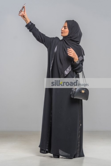 Middle Eastern woman taking a selfie|