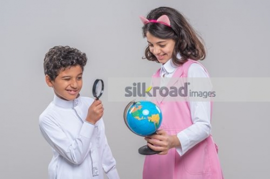 Kids looking at the globe