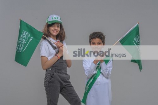 Kids carrying the KSA Flag