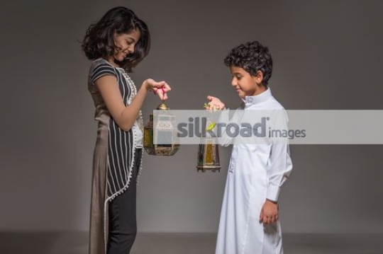 Young Arab kids carrying the Ramadan Lantern|