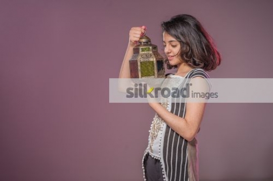 Young Arab girl looking at the Ramadan Lantern|