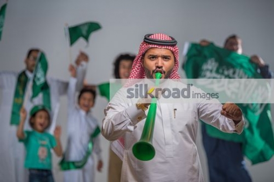 Arab family proudly celebrating their country|